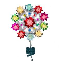 a multicolored christmas ornament hanging from a hook on a white background