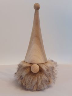 a wooden gnome's hat with fur on it