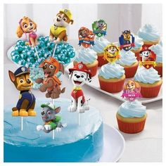 a birthday cake with cupcakes and paw patrol characters on it's top