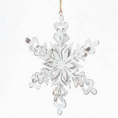 a white snowflake ornament hanging from a string on a white background