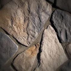 a stone wall with cracks in it that looks like they have been cut into pieces