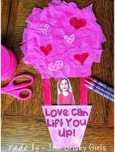 a pink paper tree with hearts and the words love can lift you up