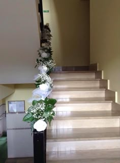 the flowers are sitting on the stairs in the hallway