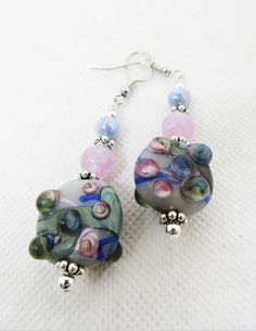 the earrings are decorated with glass beads