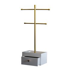 a white box with a gold cross on top and two drawers below it, in front of a white background