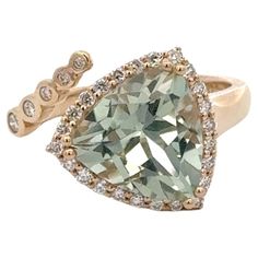 Trillion shape Mint Green Quartz gemstone ring, 3.11 Carats, flanked with 29 round brilliants weighing 0.24 carats in 14 karat yellow gold. Green Quartz, Gemstone Ring, Round Brilliant, Mint Green, Fashion Rings, Diamond Ring, Gemstone Rings, Jewelry Rings, Yellow Gold