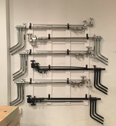 there are many pipes on the wall in this room