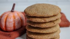 a stack of cookies next to a pumpkin