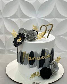 a white cake with black and gold decorations