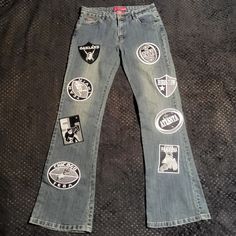 Blue Denim Bootcut Jeans By Le More With All Over Appliques Of Embroidered Grayscale Football-Themed Patches. Tagged Size 11. See Measurements For A Good Fit: Waist = 32", Inseam = 33.5, Rise = 9". Excellent Used Condition. See Photos For Details. Please Comment Below With Any Questions. *Many Of Our Items Come From Estate Sales Or Other Sources, Which Means We Do Not Know Their History. We Do Not Automatically Launder Or Clean Items That Are Vintage Because We Do Not Want To Damage Them. We Als Ariat Jeans, Denim Bootcut Jeans, Bootleg Jeans, Patch Jeans, Retro Fits, Denim Patches, Patched Jeans, Curvy Jeans, How To Stretch Boots