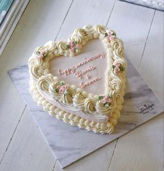 a heart shaped cake on top of a table