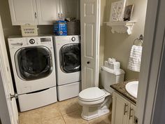 a washer and dryer in a small bathroom