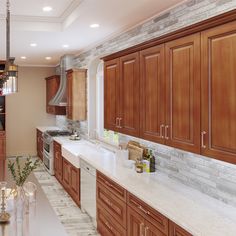 a kitchen with marble counter tops and wooden cabinets