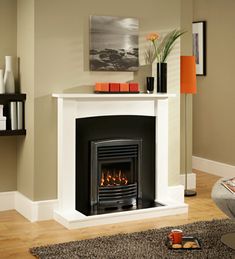 a living room with a fire place in the center and a painting on the wall