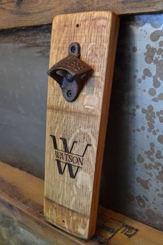 a wooden bottle opener on the side of a wall