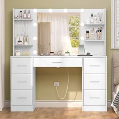 a white vanity with lights on it in front of a window and a chair next to it