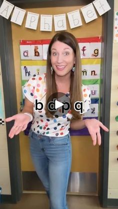 a woman standing in front of a classroom door with her hands out to the side