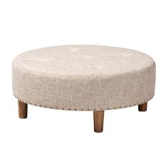 a round foot stool with wooden legs and an upholstered fabric cover on the top