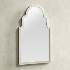 an arched mirror hanging on the wall