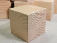 several wooden blocks are stacked on top of each other in order to form a cube