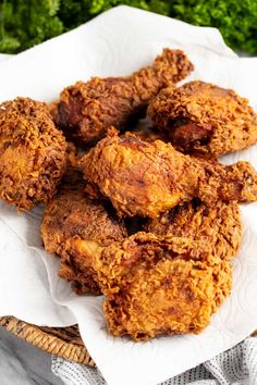 some fried food is sitting on top of a white paper towel in front of green vegetables