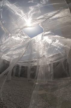 the sun shines brightly through plastic wrapped buildings