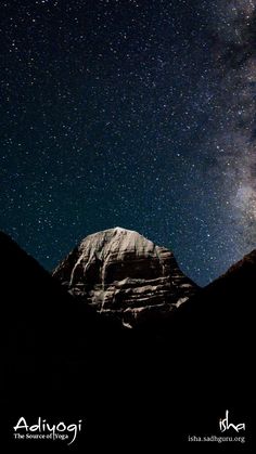 the night sky is filled with stars above some mountain tops, and there are mountains in the foreground