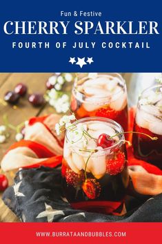 two glasses filled with cherries and ice on top of a cloth next to an american flag