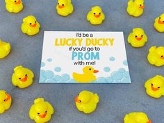 there are many rubber ducks in front of a sign that says, i'd be a lucky ducky if you go to home coming with me