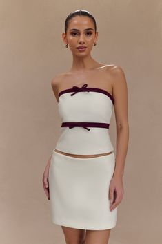 Tied with grace. Step into sophistication with the AISHA Strapless Suiting Top, a stunning piece that redefines classic style. Featuring a sleek centre back zip closure for a seamless fit, this fitted longline top showcases playful contrast panel and bow detailing, perfect for both formal and festive occasions. Fully lined for comfort, this top elongates the torso and flatters your silhouette, making it an essential addition to your wardrobe. Pair it with the Aisha Suiting Mini Skirt for an unfo Nye Outfits, Easy Wear, Long A Line, A Line Skirts, Latest Fashion Trends, Mini Skirt, Latest Fashion, Classic Style, Mini Skirts