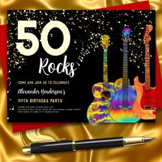 a 50th birthday party with guitars on it and a pen sitting next to the card