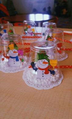 there are many glass cups with snowmen on them