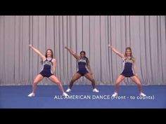 four young women in cheerleader outfits are dancing on a blue carpet with curtains behind them