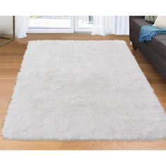 a large white rug in the middle of a living room