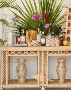 a table topped with lots of bottles and vases