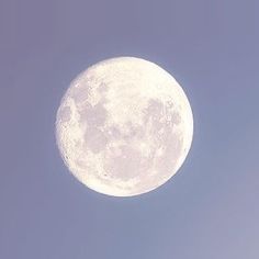 an airplane flying in front of the moon