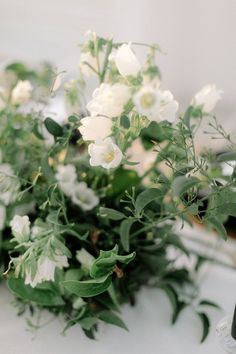 white flowers and greenery on a table