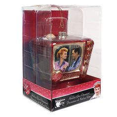 a christmas ornament in a box with a picture of two people on it