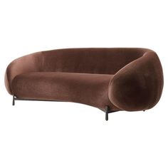 the curved sofa is brown with black legs