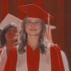 a woman in a graduation gown and cap