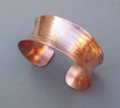 Elegant with an ultra modern aesthetic, this slim line copper cuff bracelet is a comfy easy-to-wear accessory. Handmade in solid copper, it's first hammered for an organic willow bark texture, then molded into curvy contours. This cuff bracelet is so versatile, it goes as well with denim blues as it does with your favorite cocktail dress. Also makes an ideal 7th anniversary gift as copper is the traditional gift for couples celebrating seven years of marriage. Band width is just over 1 inch (26- Bronze Cuff Bracelet, 19th Anniversary Gifts, Handmade Copper Bracelet, Bronze Anniversary Gifts, Bronze Anniversary, Small Drop Earrings, Copper Anniversary Gifts, Copper Anniversary, 7th Anniversary Gifts