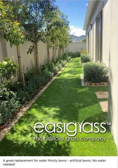 an image of a backyard with artificial grass and trees in the back yard, as well as landscaping