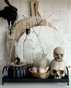 halloween decorations with skulls and bottles on a shelf