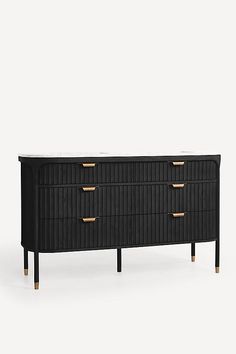 a black dresser with gold handles and drawers on it's sides, against a white background