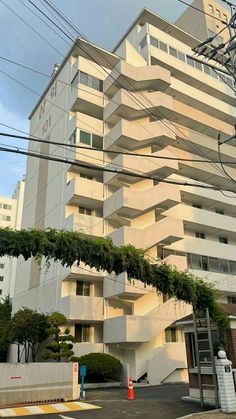 an apartment building with many balconies on the top floor and one story below