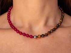 "Refine your style with this exquisite choker necklace, handcrafted with a striking combination of beaded Brown Tiger's Eye, Silver Hematite and Fuschia Jade strung on black knotted silk. Each bead is carefully selected for its natural variations, lending the piece a unique and nuanced identity. The black knotted silk provides a sophisticated backdrop for the shimmering beads, while the choker style adds a bold and contemporary touch to any outfit. Whether you're dressing up for a special occasion or elevating your everyday look, this handmade modern crystal jewelry is designed to inspire and uplift. Experience the transformative power of crystals with this stunning choker necklace. Brown tiger's eye is believed to promote grounding and stability, enhancing inner strength, courage, and sel Elegant Choker With Natural Stones And Round Beads, Elegant Choker With Round Natural Stones, Beaded Necklaces With Round Beads For Healing, 8mm Bead Necklaces For Gift, Spiritual Gemstone Beads Choker Jewelry, Healing Beaded Necklaces With Round Beads, Elegant Multicolor Beaded Necklace With 8mm Beads, Spiritual Round Beads Choker As A Gift, Healing Gemstone Beaded Necklaces