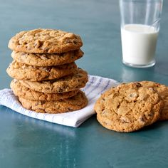 a stack of cookies next to a glass of milk