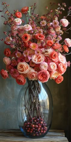 a vase filled with lots of flowers on top of a table