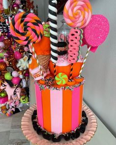 there is a cake decorated with candy and lollipops