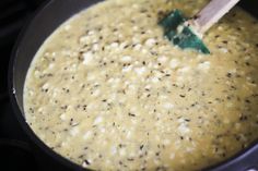 a wooden spoon in a pot filled with food